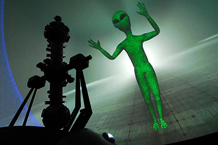 Grünes Männchen am Planetarium-Himmel
